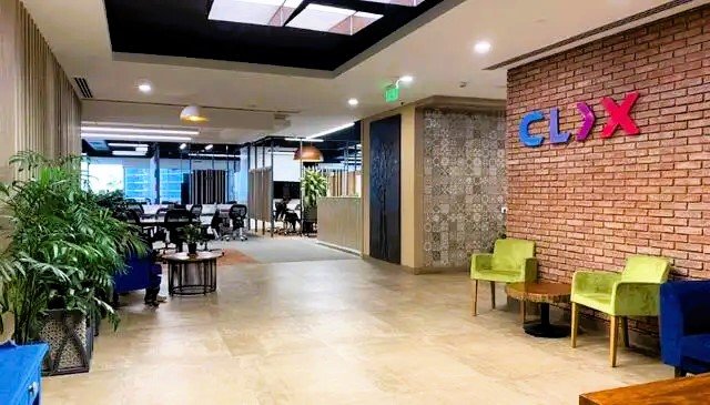 Modern corporate office workspace with meeting room and collaborative setup